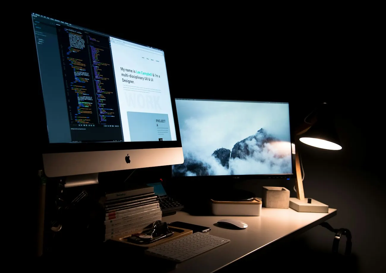 Postazione di progettazione web con monitor e lampada